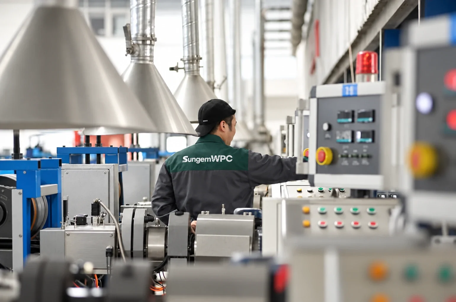 A worker adjusting equipment on the WPC production line