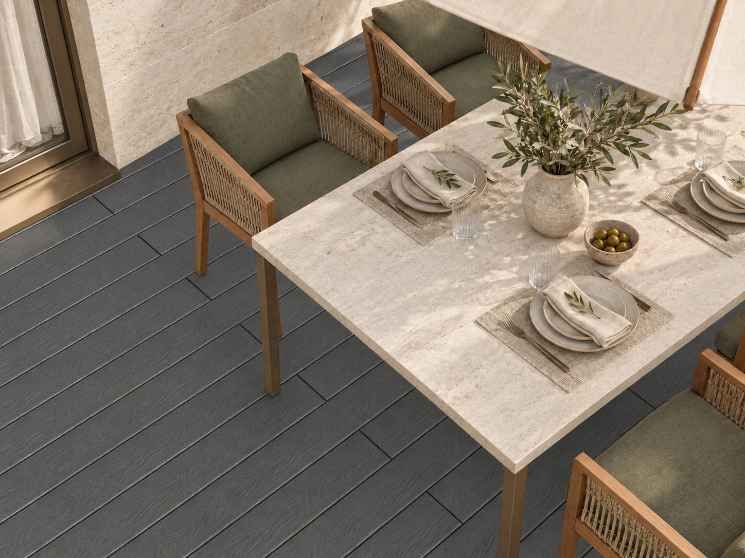 Shield Series composite decking beneath an outdoor dining table and woven chairs